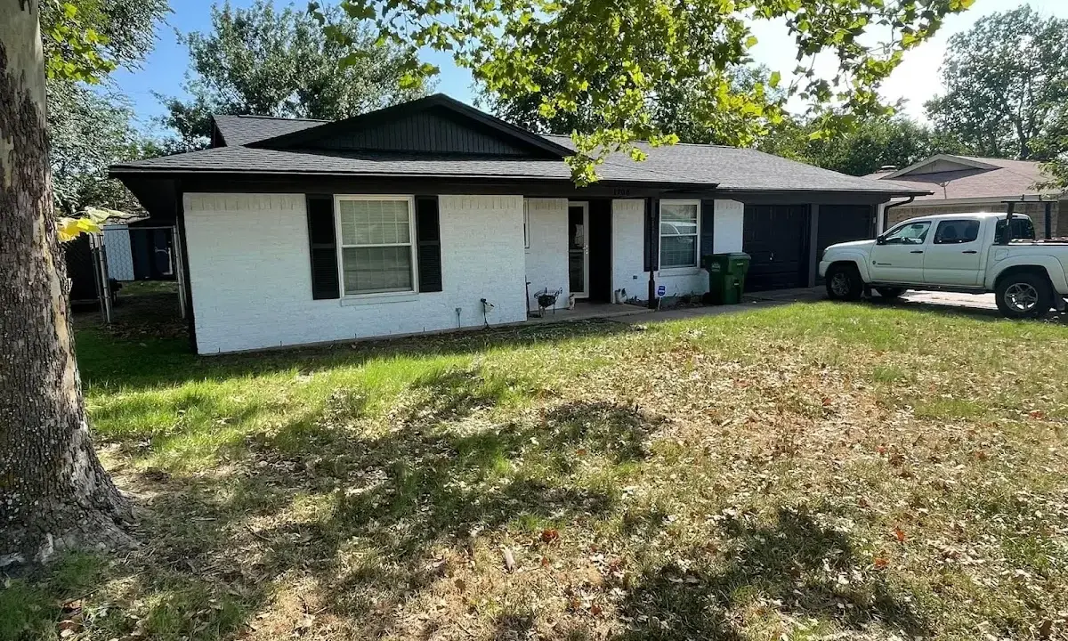 Professional roofing crew working on a residential roof in Lindale
